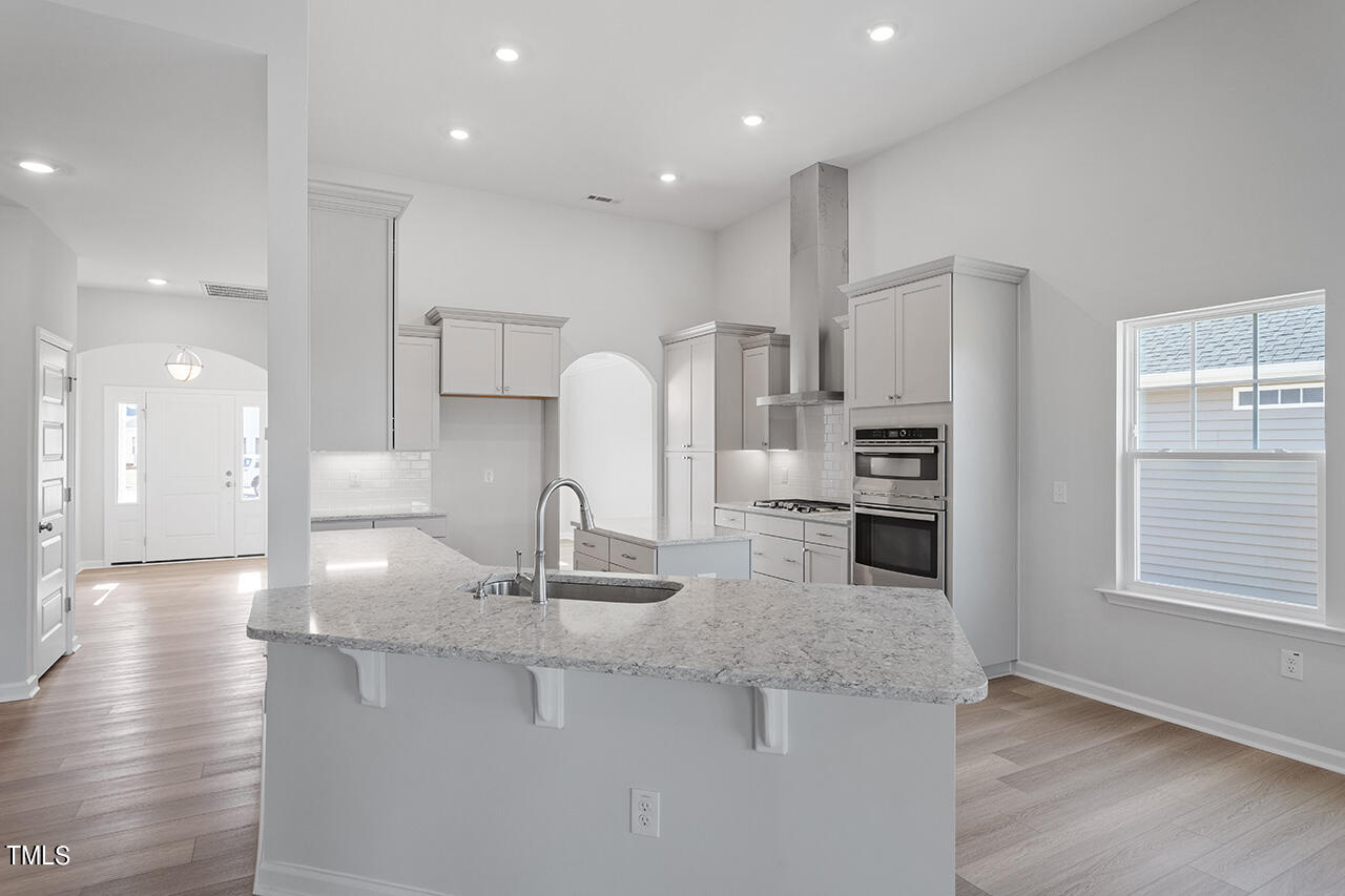 63 Beech Tree Way, Unit 139 Garner, NC 27529 - Photo 10 of 25 a kitchen with stainless steel appliances granite countertop a sink refrigerator and cabinets