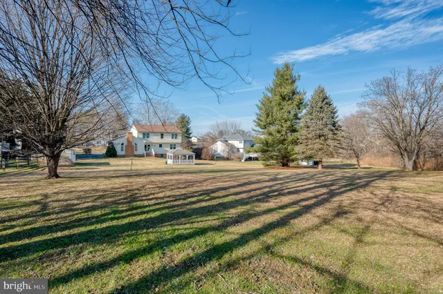 a view of a house with a yard and porch
