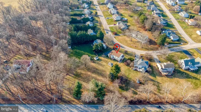 an aerial view of a house with a yard basket ball court and outdoor seating