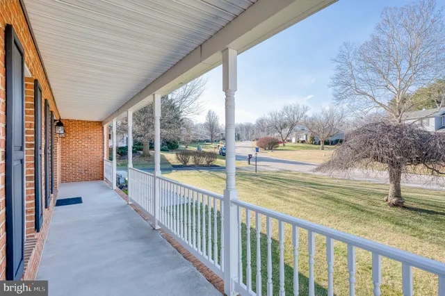 a view of a porch and yard with wooden fence