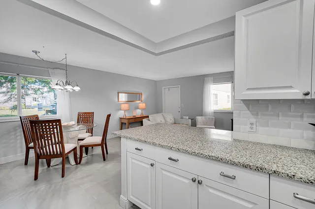 a view of a kitchen and dining table cabinets