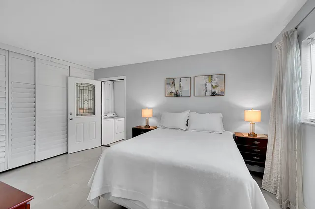 a bedroom with a bed and a painting on the wall