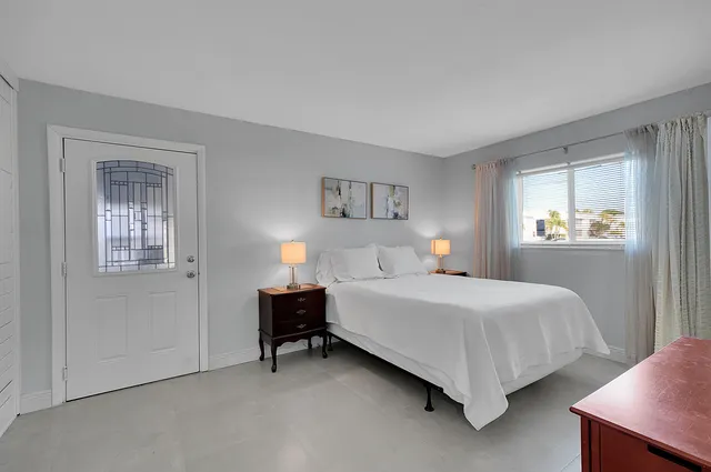 a bedroom with a bed and a table in it