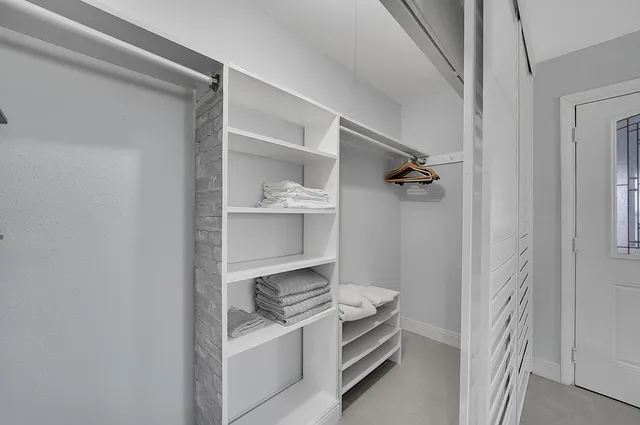 a room with a stove and a white cabinet