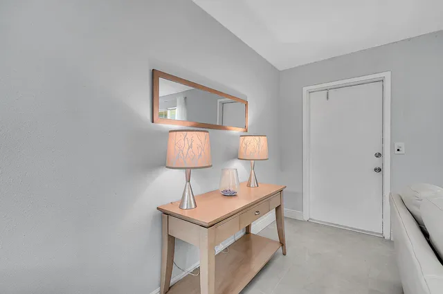 a lamp on a table in a room with a table and couch