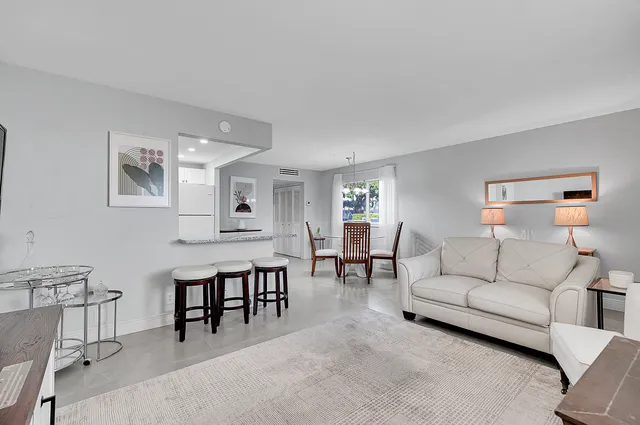 a living room with furniture and a dining table