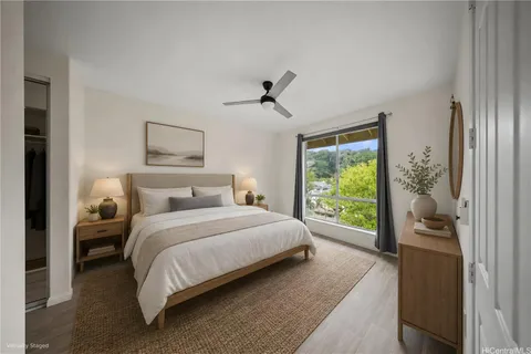a bedroom with a bed and a large window