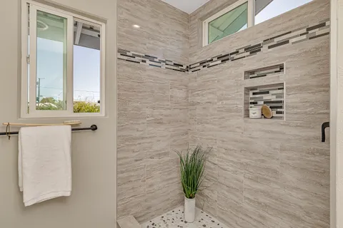 a bathroom with a shower and a window
