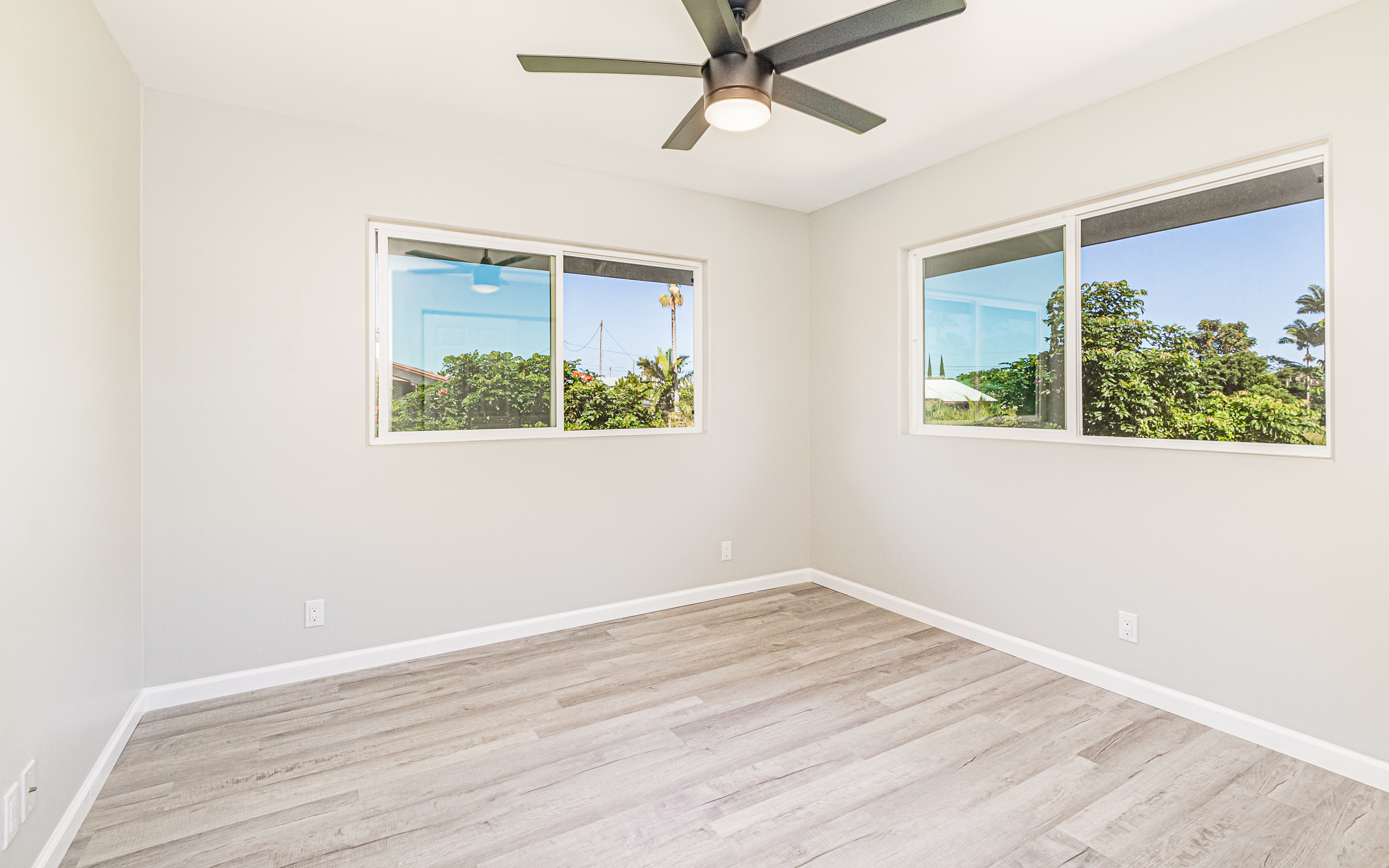 508 Ekela Street Hilo, HI 96720 - Photo 18 of 30 an empty room with wooden floor and windows