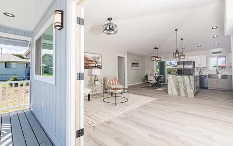 a living room with furniture and kitchen view