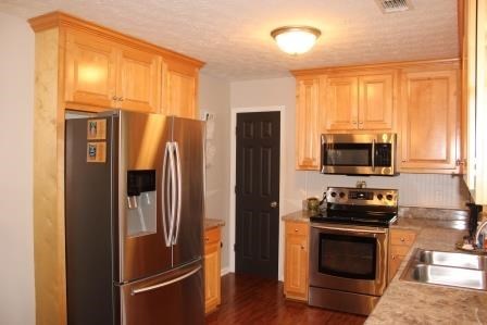 222 Reedy Creek Road Forsyth, GA 31029 - Photo 6 of 15 a kitchen with stainless steel appliances a refrigerator stove and microwave