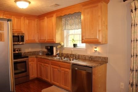 222 Reedy Creek Road Forsyth, GA 31029 - Photo 7 of 15 a kitchen with stainless steel appliances granite countertop a sink stove and microwave