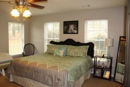 222 Reedy Creek Road Forsyth, GA 31029 - Photo 9 of 15 a bedroom with a bed and a chandelier