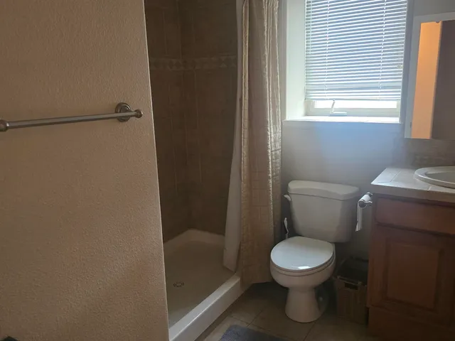 a white toilet sitting next to a window