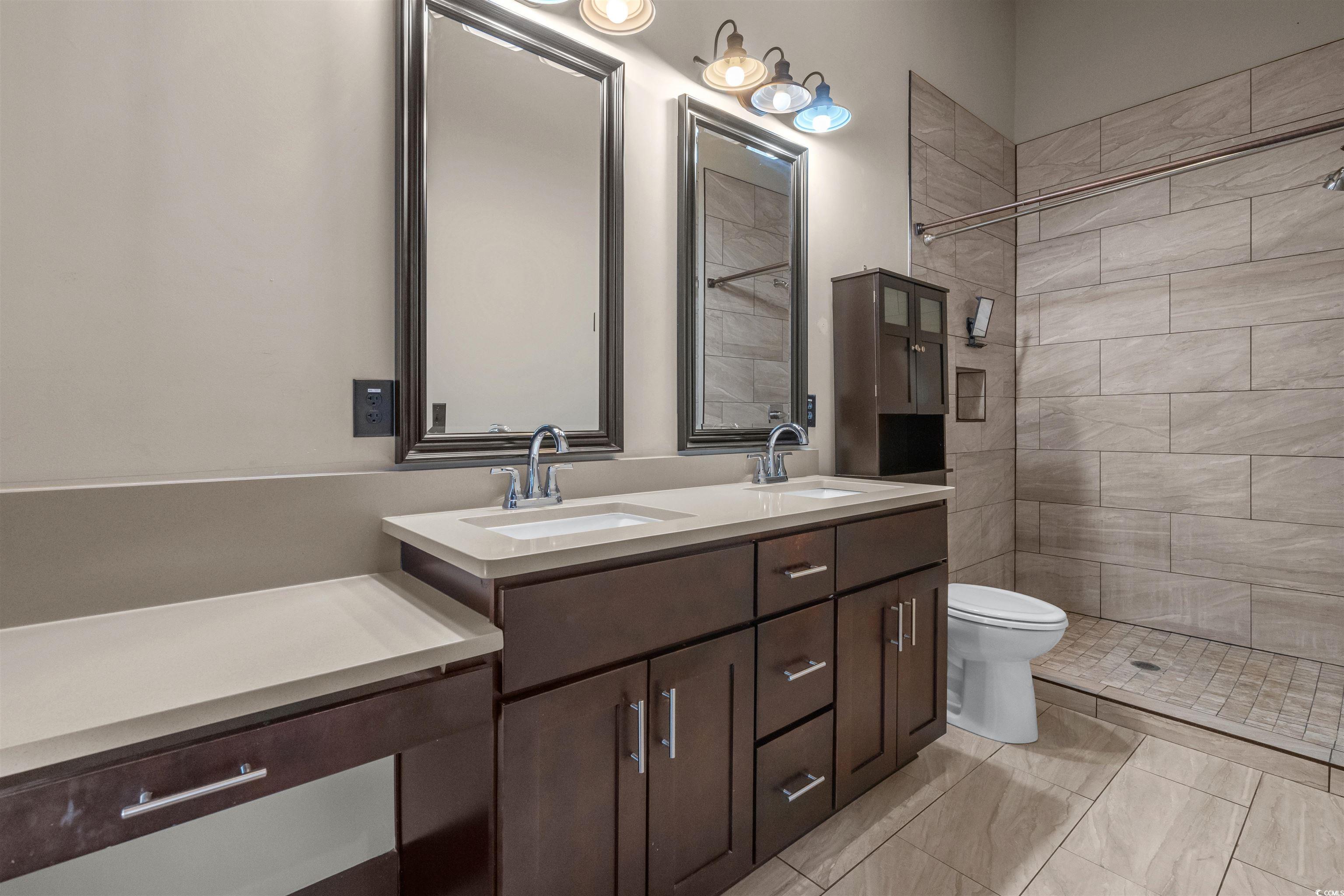 80 Shady Oak Lane Murrells Inlet, SC 29576 - Photo 15 of 31 Full bathroom with double vanity and a shower stall