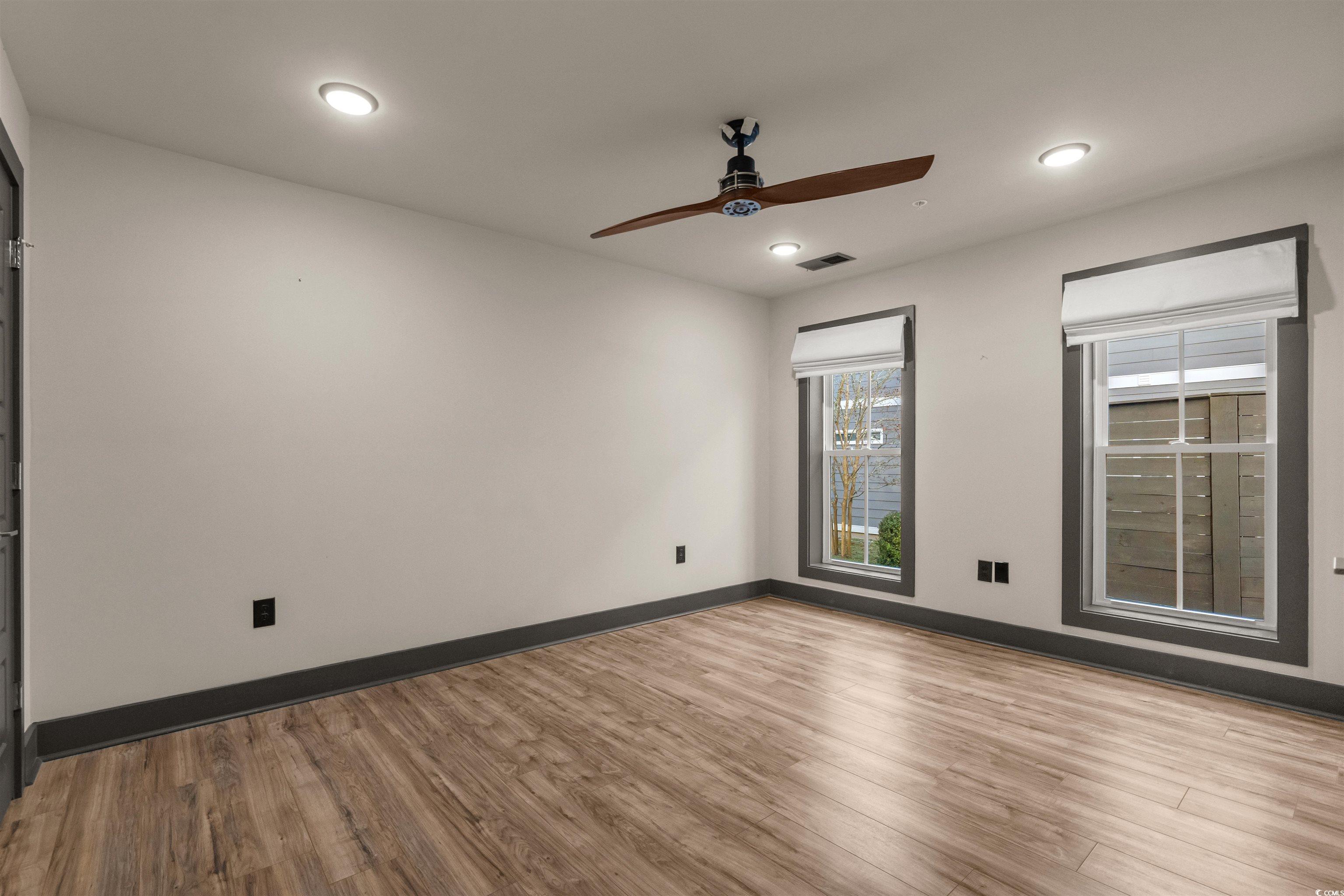 80 Shady Oak Lane Murrells Inlet, SC 29576 - Photo 21 of 31 Unfurnished room featuring wood finished floors, a ceiling fan, and recessed lighting