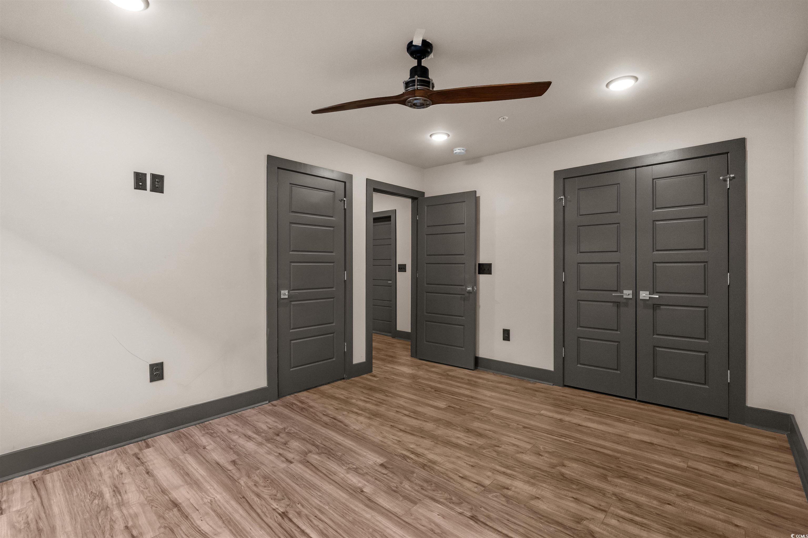 80 Shady Oak Lane Murrells Inlet, SC 29576 - Photo 22 of 31 Unfurnished bedroom with wood finished floors, a ceiling fan, recessed lighting, and a closet