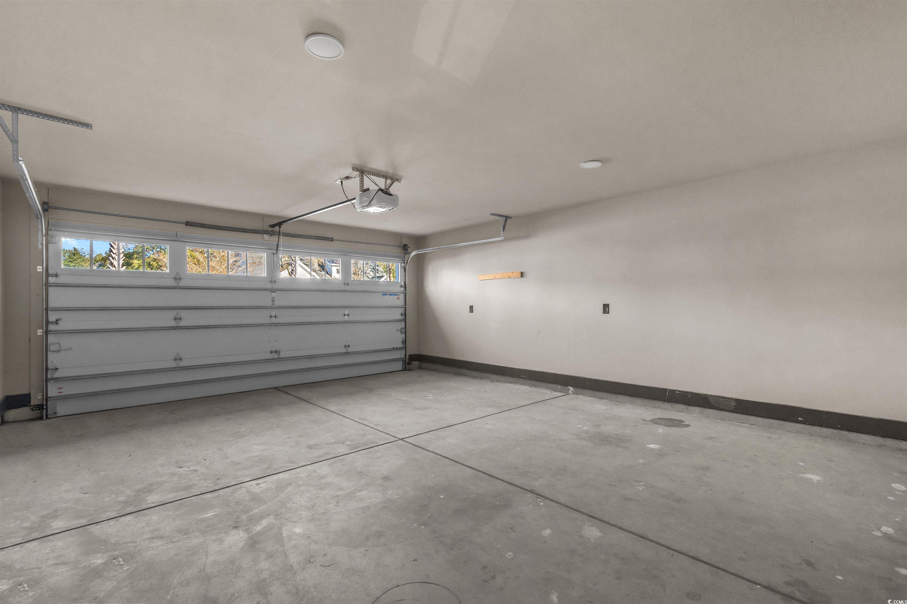 80 Shady Oak Lane Murrells Inlet, SC 29576 - Photo 26 of 31 Garage featuring baseboards and a garage door opener