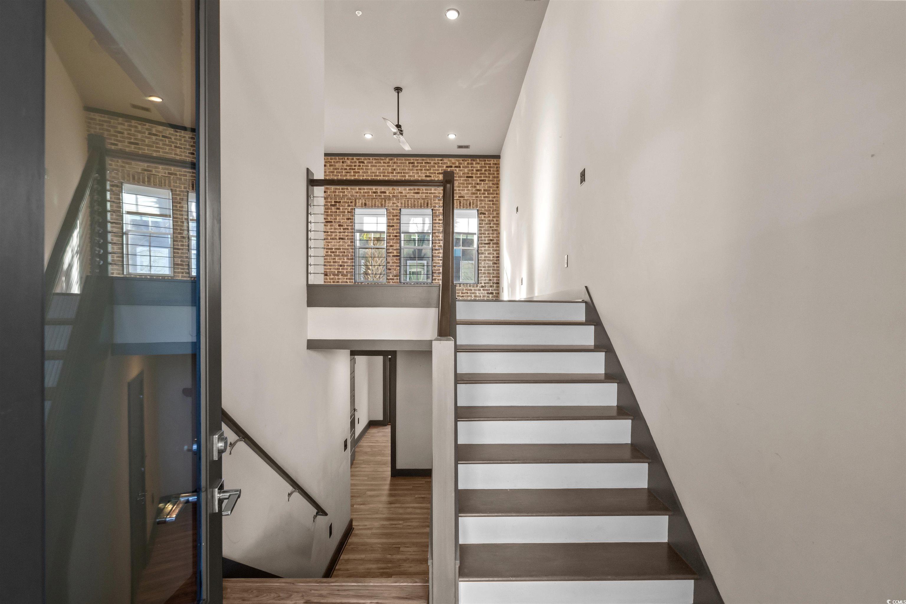 80 Shady Oak Lane Murrells Inlet, SC 29576 - Photo 3 of 31 Stairway with wood finished floors, brick wall, and recessed lighting