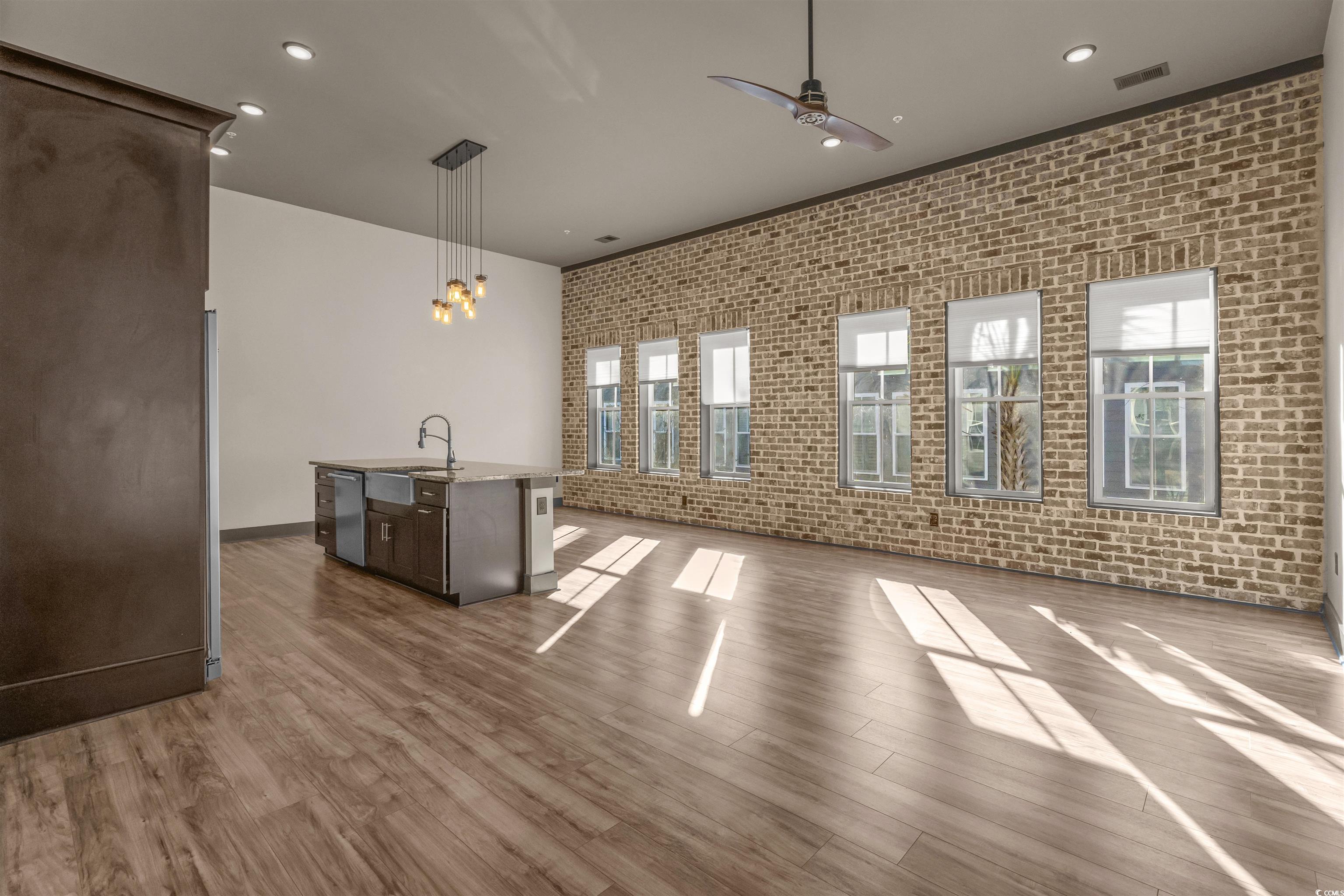 80 Shady Oak Lane Murrells Inlet, SC 29576 - Photo 4 of 31 Unfurnished living room featuring brick wall, recessed lighting, wood finished floors, and ceiling fan
