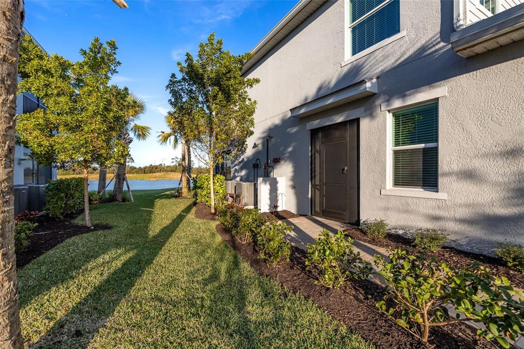 14186 Poppy Fld Loop, Unit 4911 Punta Gorda, FL 33955 - Photo 11 of 48 a front view of a house with a yard