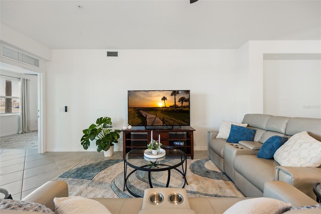14186 Poppy Fld Loop, Unit 4911 Punta Gorda, FL 33955 - Photo 14 of 48 a living room with furniture and a flat screen tv