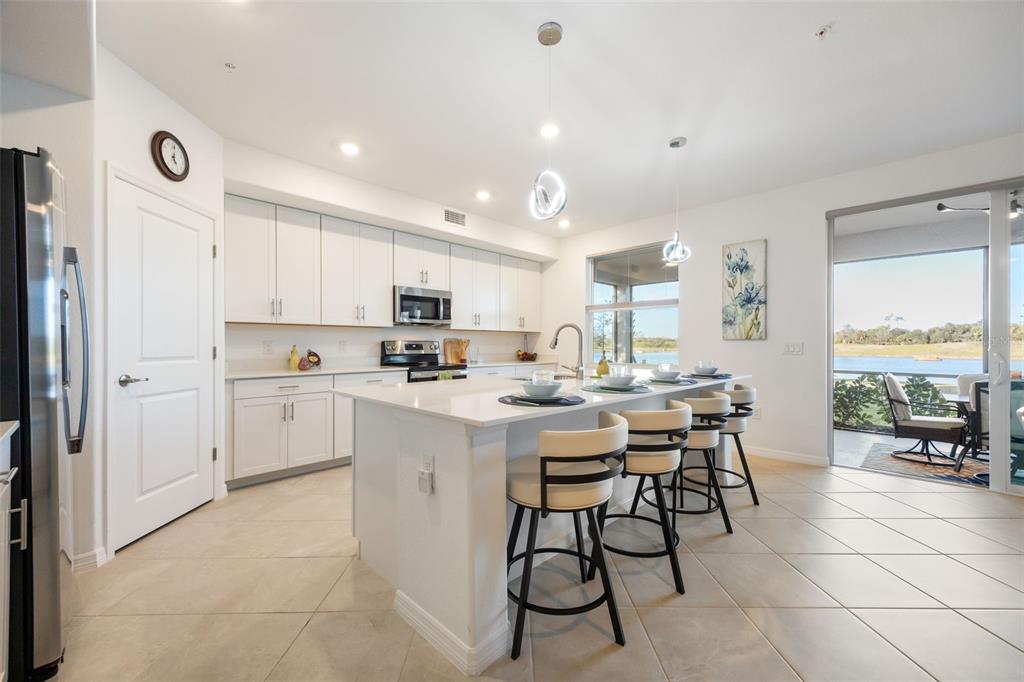 14186 Poppy Fld Loop, Unit 4911 Punta Gorda, FL 33955 - Photo 16 of 48 a kitchen with a sink a counter top space and stainless steel appliances