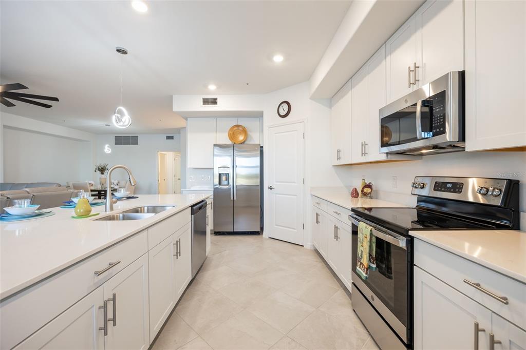 14186 Poppy Fld Loop, Unit 4911 Punta Gorda, FL 33955 - Photo 18 of 48 a kitchen with stainless steel appliances granite countertop a sink and cabinets