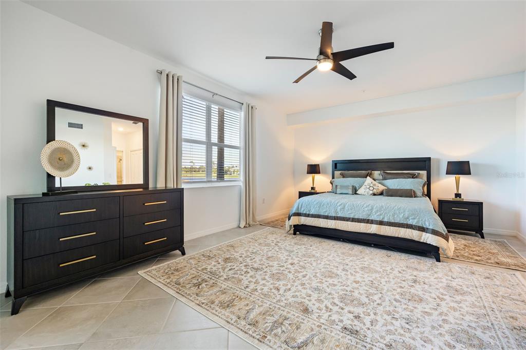 14186 Poppy Fld Loop, Unit 4911 Punta Gorda, FL 33955 - Photo 22 of 48 a bedroom with a bed and window with lamp