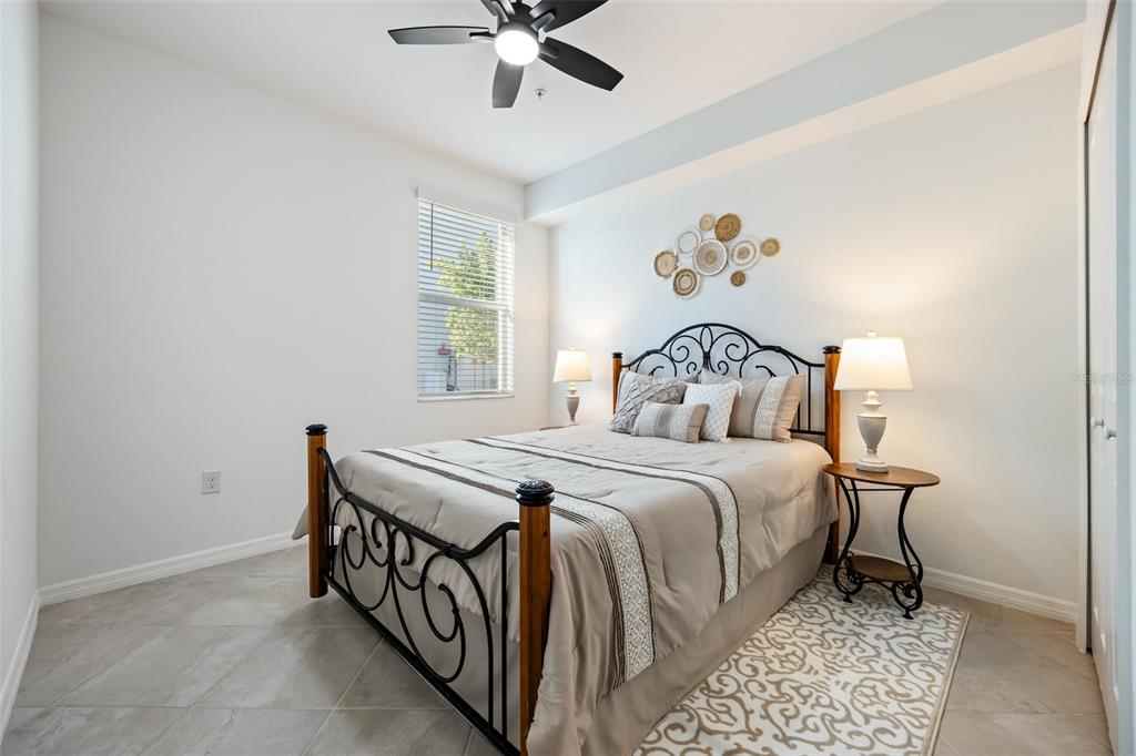 14186 Poppy Fld Loop, Unit 4911 Punta Gorda, FL 33955 - Photo 25 of 48 a bedroom with a bed and a chandelier