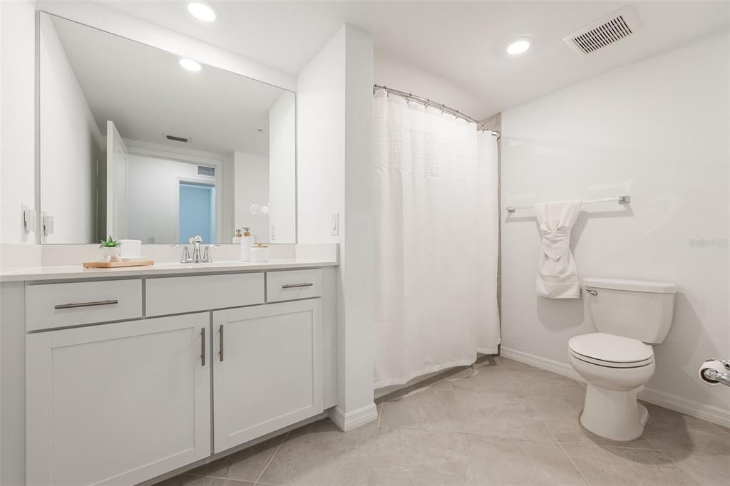 14186 Poppy Fld Loop, Unit 4911 Punta Gorda, FL 33955 - Photo 26 of 48 a bathroom with a toilet sink and mirror