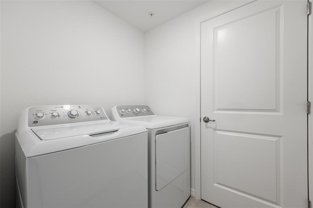 14186 Poppy Fld Loop, Unit 4911 Punta Gorda, FL 33955 - Photo 28 of 48 a utility room with dryer and washer
