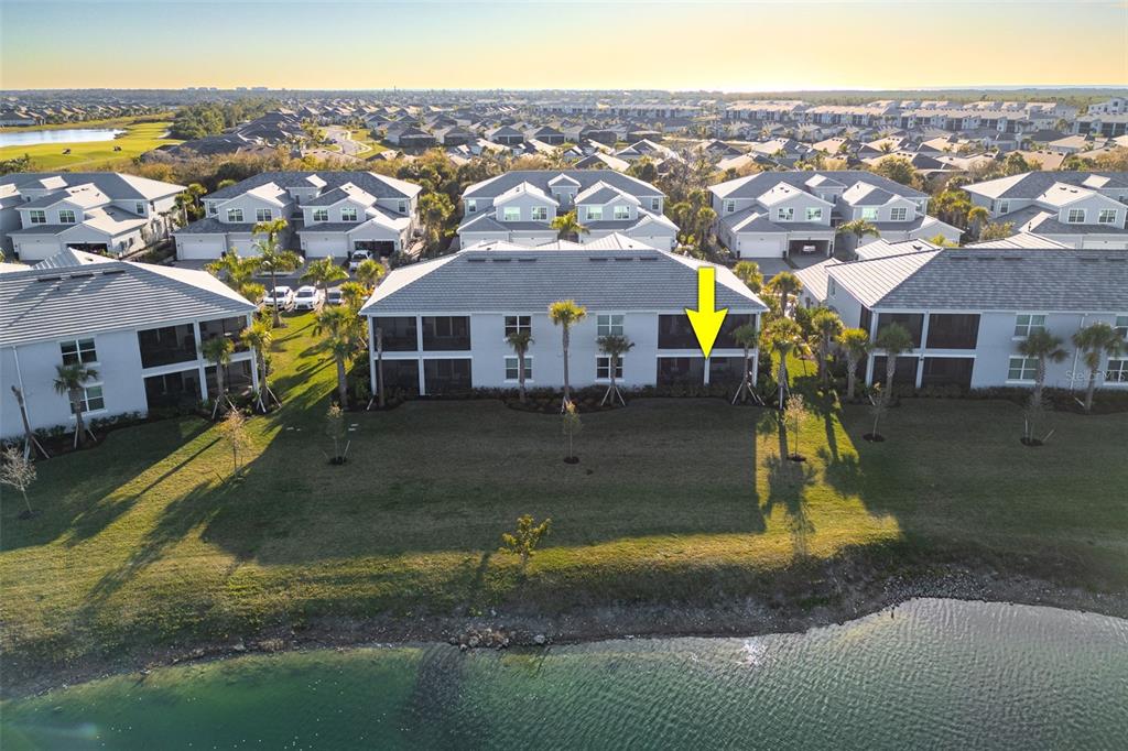 14186 Poppy Fld Loop, Unit 4911 Punta Gorda, FL 33955 - Photo 32 of 48 a view of residential houses with yard and ocean view