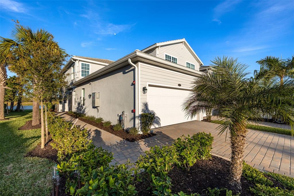 14186 Poppy Fld Loop, Unit 4911 Punta Gorda, FL 33955 - Photo 10 of 48 a front view of a house with garden