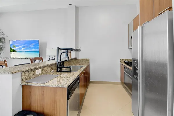 a dining room with furniture and kitchen view