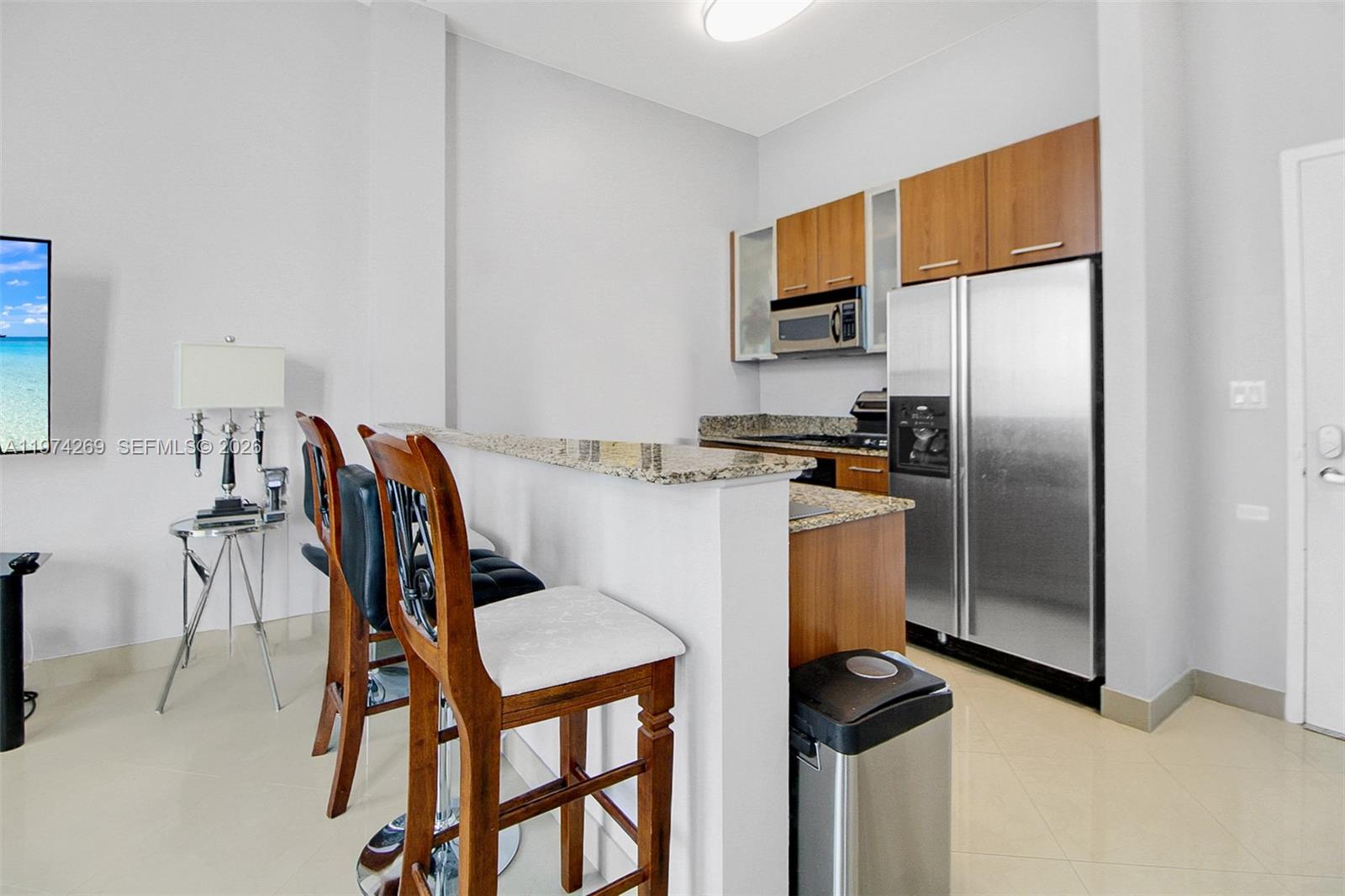 9066 Southwest 73rd Court, Unit 203 Miami, FL 33156 - Photo 13 of 28 a dining room with furniture and kitchen view