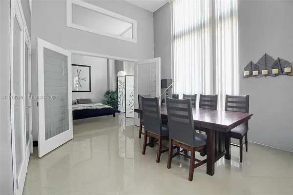 a view of a dining room with furniture and a window