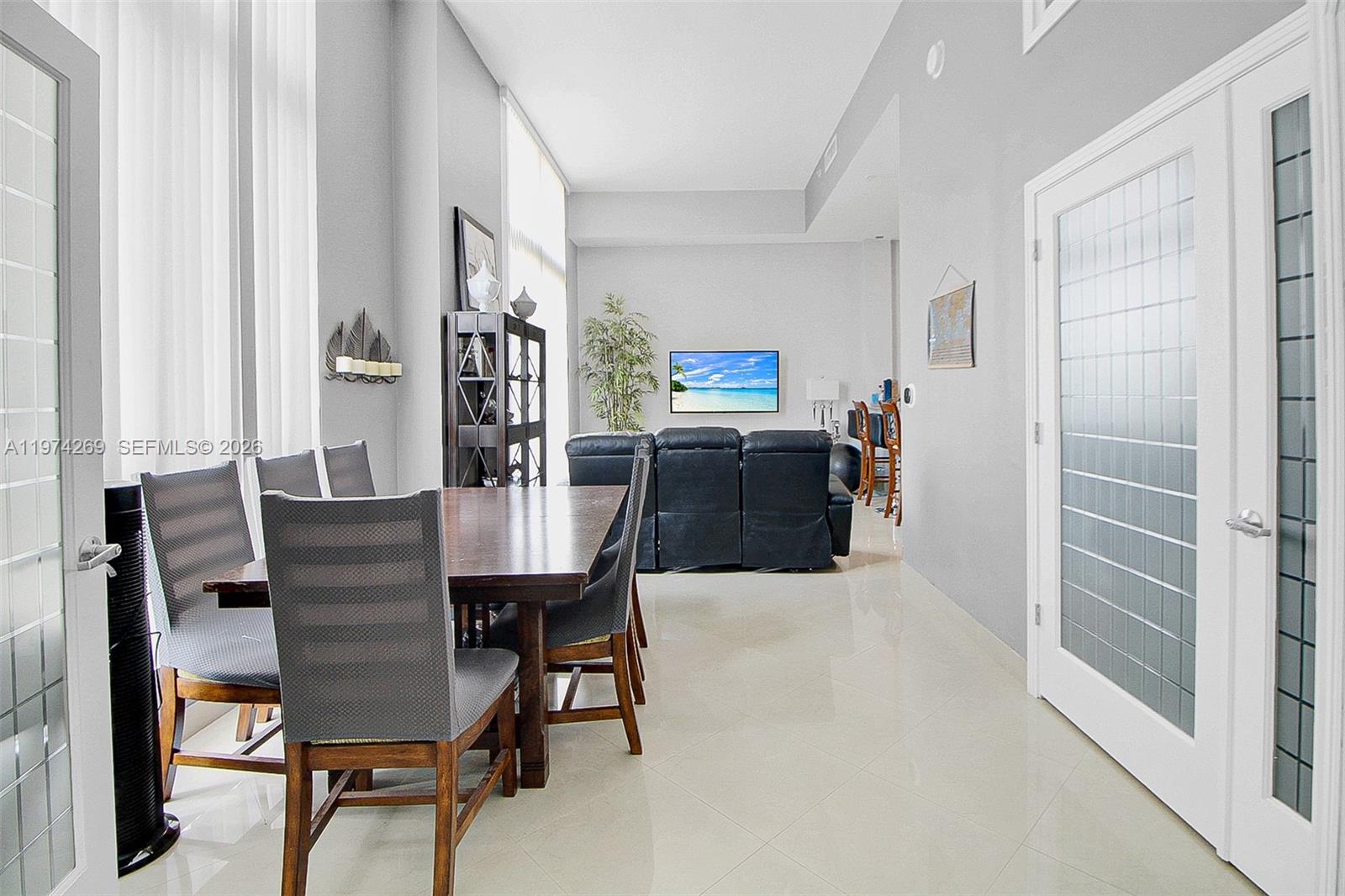 9066 Southwest 73rd Court, Unit 203 Miami, FL 33156 - Photo 6 of 28 a view of a dining room with furniture and a window