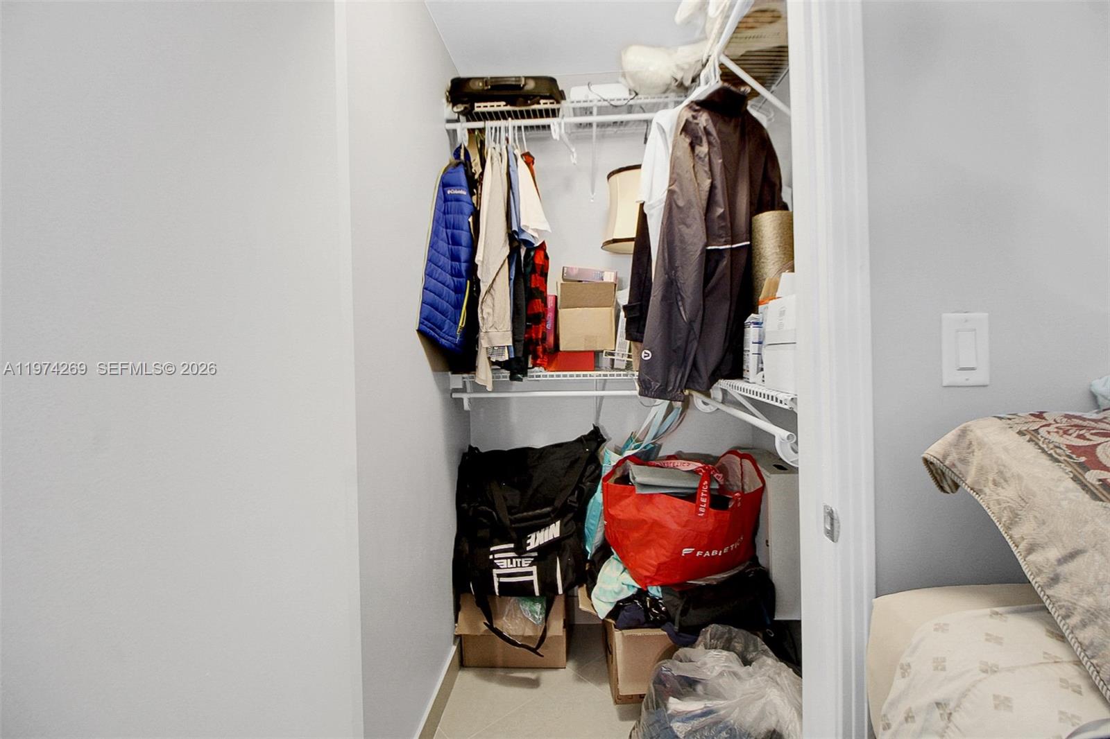 9066 Southwest 73rd Court, Unit 203 Miami, FL 33156 - Photo 10 of 28 a view of walk in closet with clothes and shoes