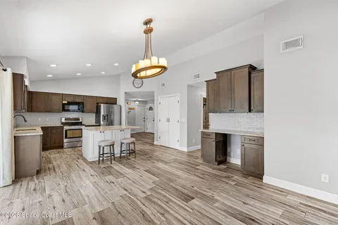 a view of kitchen with sink microwave and stove