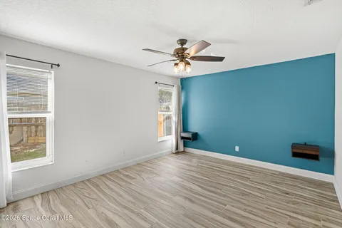 a view of room with window and ceiling fan