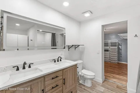 a bathroom with a double vanity sink toilet and shower