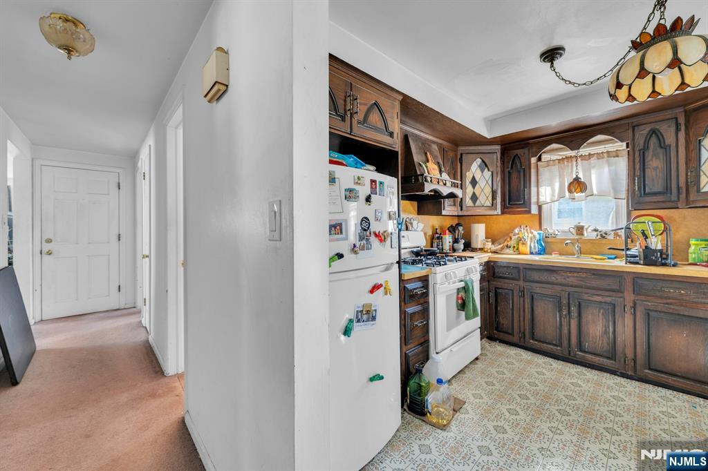 648 Milton Avenue Lyndhurst, NJ 07071 - Photo 19 of 29 a kitchen with stainless steel appliances a refrigerator and cabinets