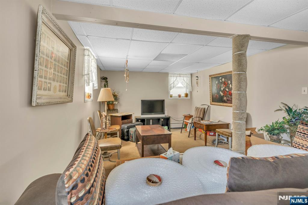 648 Milton Avenue Lyndhurst, NJ 07071 - Photo 25 of 29 a living room with furniture and a flat screen tv