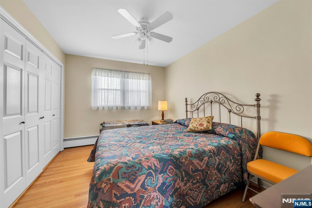 648 Milton Avenue Lyndhurst, NJ 07071 - Photo 7 of 29 a bedroom with a bed and a chandelier