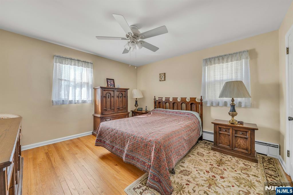 648 Milton Avenue Lyndhurst, NJ 07071 - Photo 8 of 29 a bedroom with a large bed and a chandelier