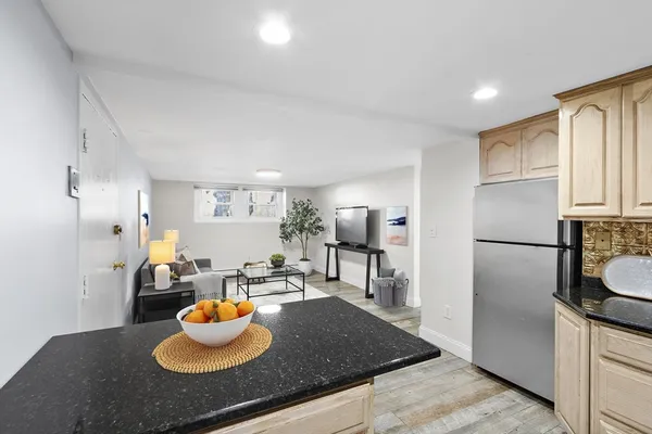 a kitchen with a refrigerator and a stove top oven