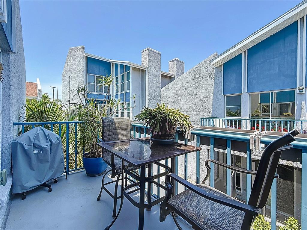 230 Medallion Boulevard, Unit G Madeira Beach, FL 33708 - Photo 31 of 38 a view of a house with backyard and sitting area