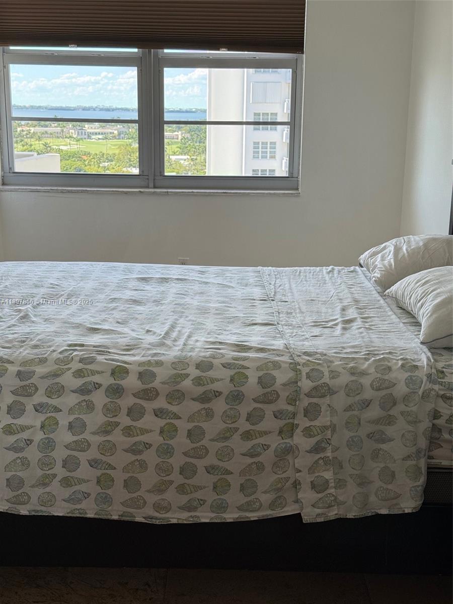 5701 Collins Avenue, Unit 1207 Miami Beach, FL 33140 - Photo 11 of 44 a view of a closet area with wooden floor