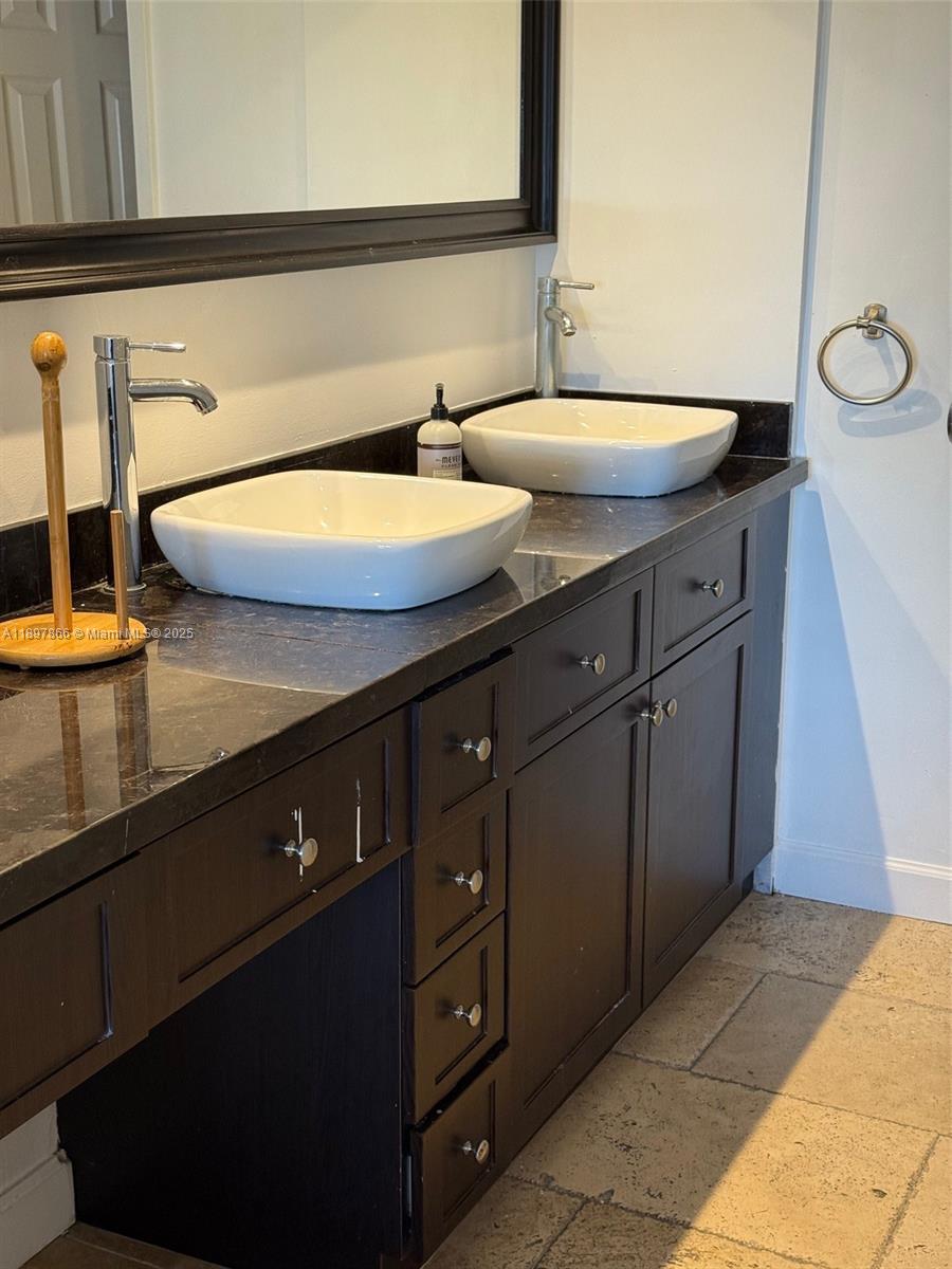 5701 Collins Avenue, Unit 1207 Miami Beach, FL 33140 - Photo 13 of 44 a bathroom with a sink and a mirror